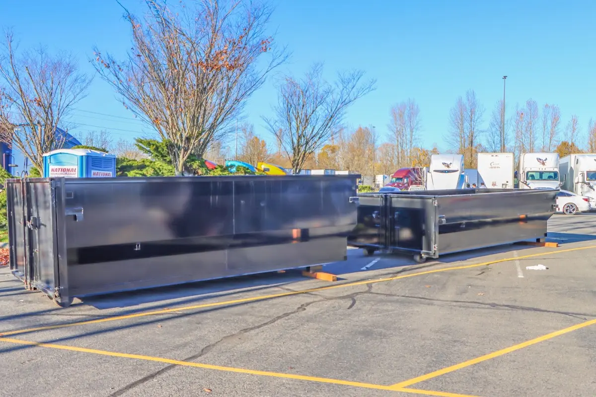 Professional dumpster rental service with roll-off container on residential driveway in Tyrone